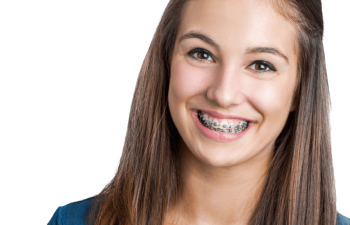 Teenage girl with long brown hair wearing a blue shirt and braces, smiling at the camera against a plain background.