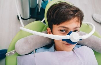 Little boy in a dental chair getting inhalation sedation.