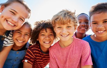 a muliticultural group of smiling happy children